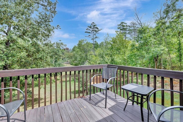 wooden deck featuring a yard