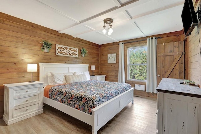 bedroom featuring light hardwood / wood-style flooring, wood walls, beamed ceiling, and coffered ceiling