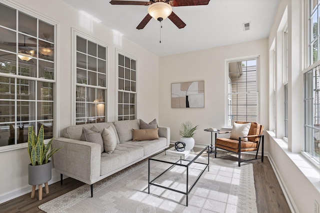 living room featuring ceiling fan and hardwood / wood-style floors