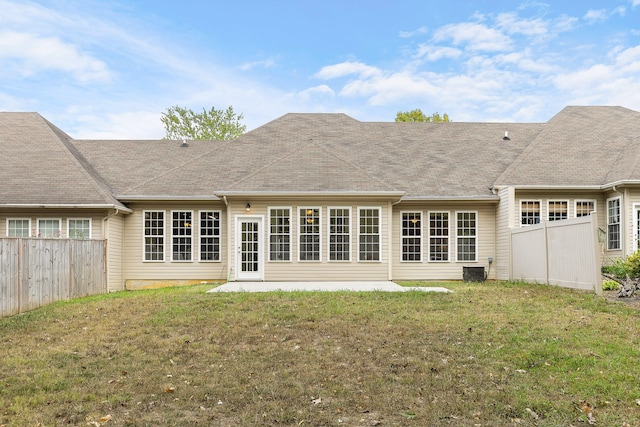 rear view of house with a lawn