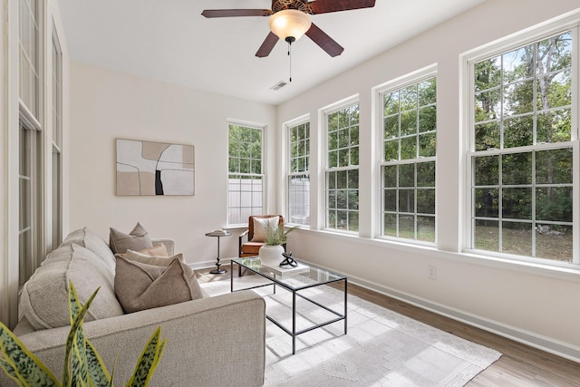 living room with light wood-type flooring and ceiling fan