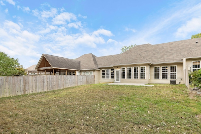 back of property featuring a lawn