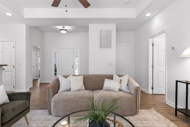 living room featuring crown molding, ceiling fan, and hardwood / wood-style flooring