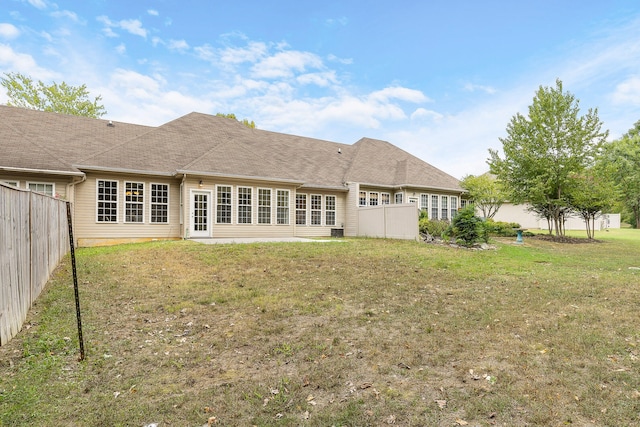 rear view of property with a yard