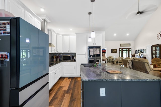 kitchen with ceiling fan, white cabinets, stainless steel appliances, and tasteful backsplash