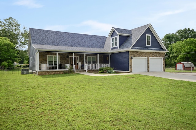 view of front facade featuring a front yard, covered porch, a garage, and central AC unit