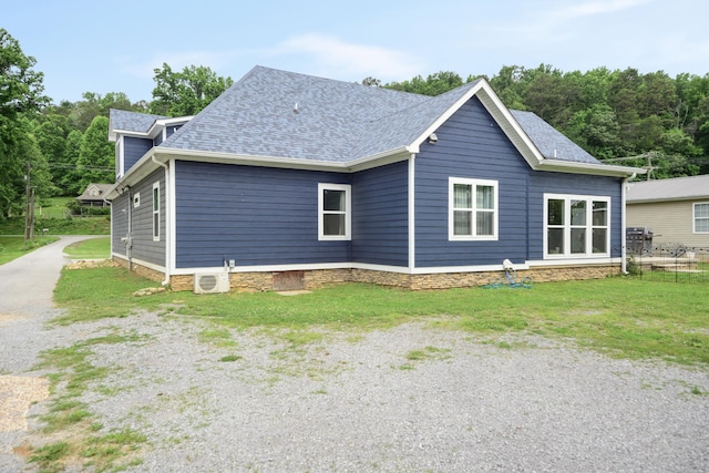 view of side of home with a lawn