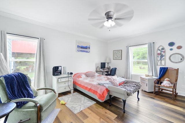 bedroom with ceiling fan, hardwood / wood-style floors, and crown molding