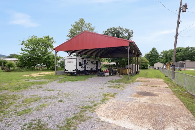 view of car parking with a carport and a yard