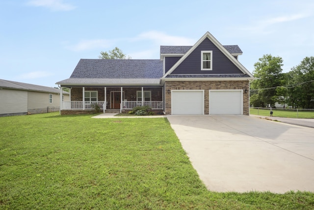 view of front facade featuring a front yard, covered porch, and a garage