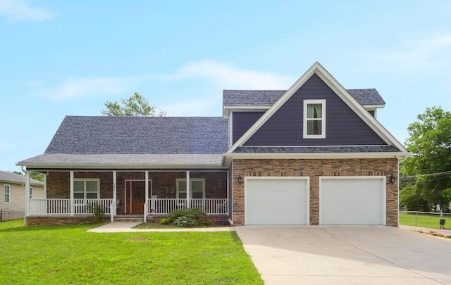 view of front of home featuring a front lawn, a garage, and a porch