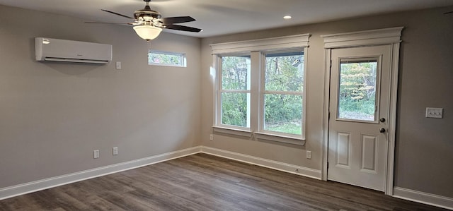 doorway with ceiling fan, dark wood-type flooring, a wall mounted air conditioner, and baseboards