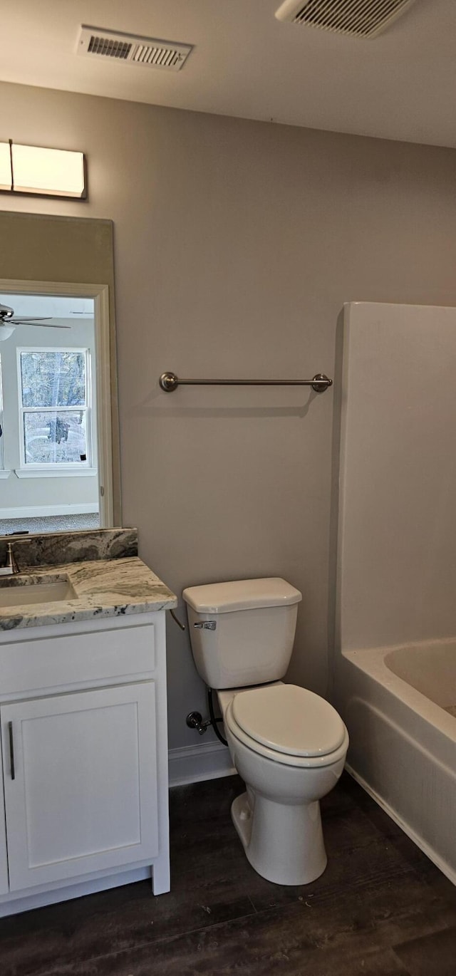 bathroom with visible vents, vanity, and wood finished floors