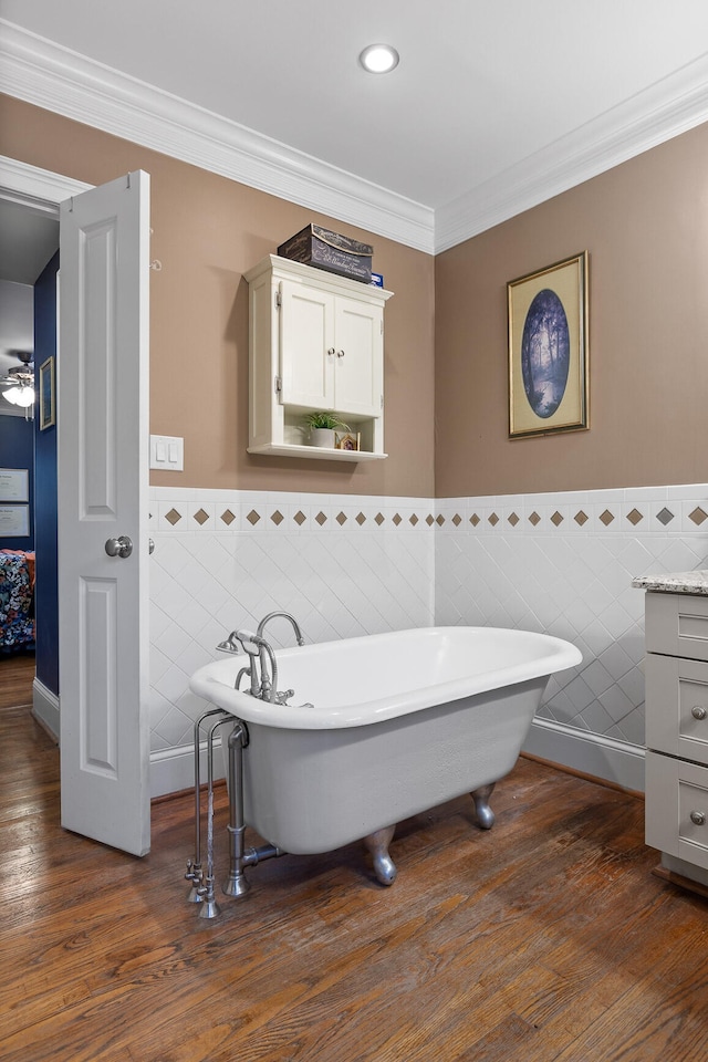 bathroom with vanity, hardwood / wood-style flooring, tile walls, and a bath