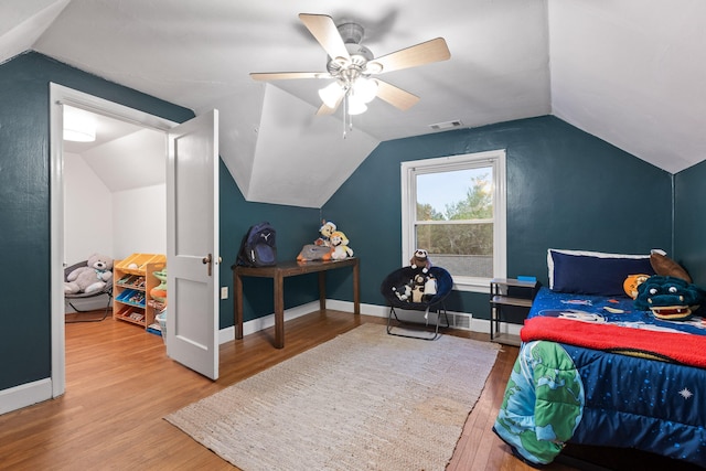 bedroom with lofted ceiling, hardwood / wood-style floors, and ceiling fan