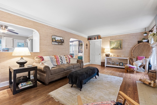 living room featuring ornamental molding, ceiling fan, hardwood / wood-style flooring, and a healthy amount of sunlight