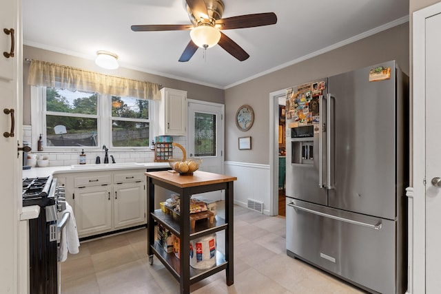 kitchen featuring white cabinetry, sink, ceiling fan, and stainless steel appliances