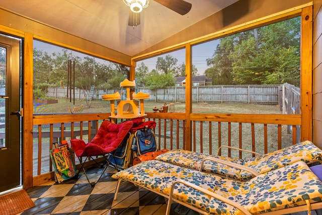 sunroom / solarium featuring lofted ceiling, ceiling fan, and a healthy amount of sunlight