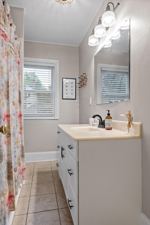 bathroom featuring tile patterned flooring, walk in shower, and vanity