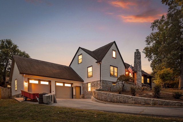 view of front of home featuring a garage and a lawn