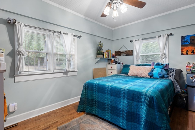 bedroom with ceiling fan, ornamental molding, and wood-type flooring