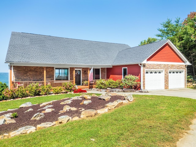 single story home with a front yard, a porch, and a garage