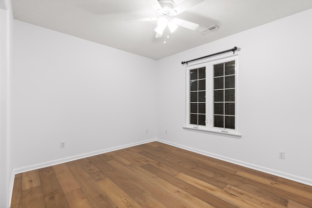 spare room with wood-type flooring and ceiling fan