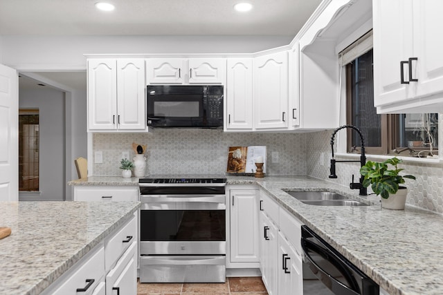 kitchen featuring light stone countertops, black appliances, white cabinetry, and sink