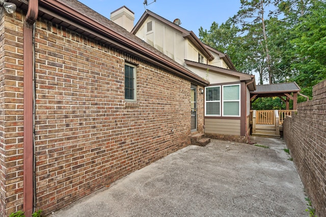 view of side of property with a patio and a gazebo