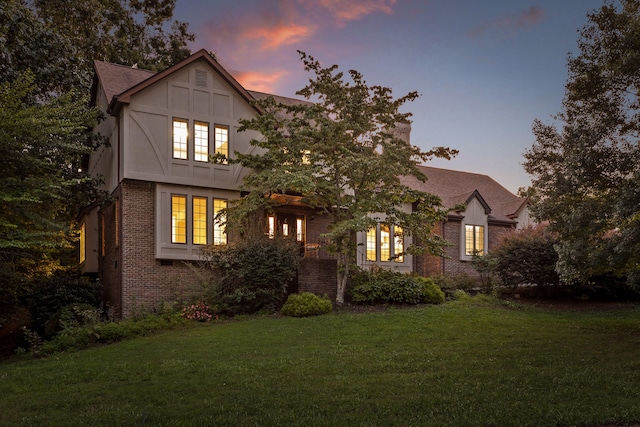 tudor-style house with a yard