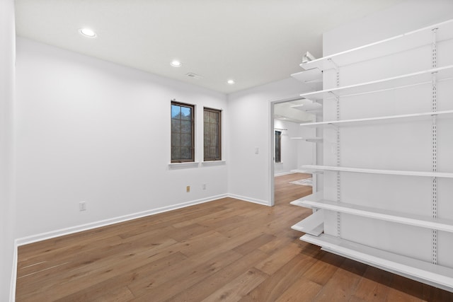 empty room with hardwood / wood-style floors