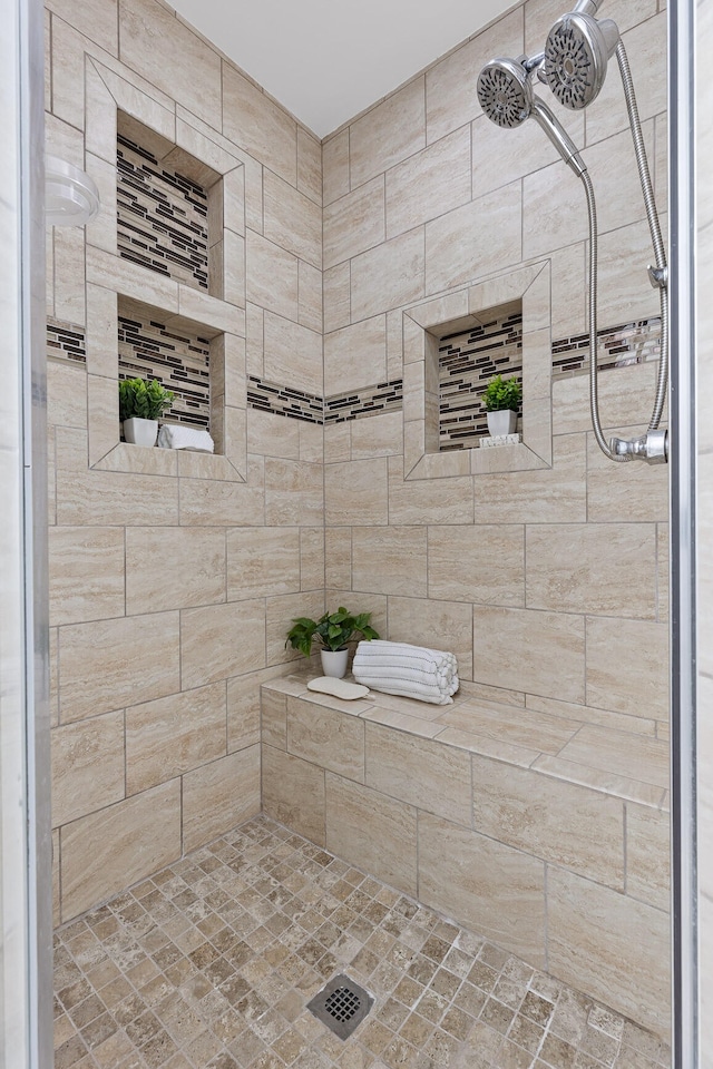 bathroom with tiled shower