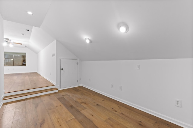 bonus room with lofted ceiling, hardwood / wood-style floors, and ceiling fan