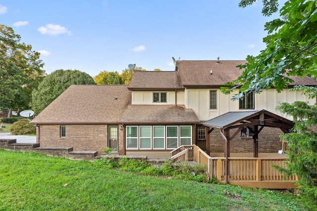 rear view of house featuring a wooden deck, a gazebo, and a yard