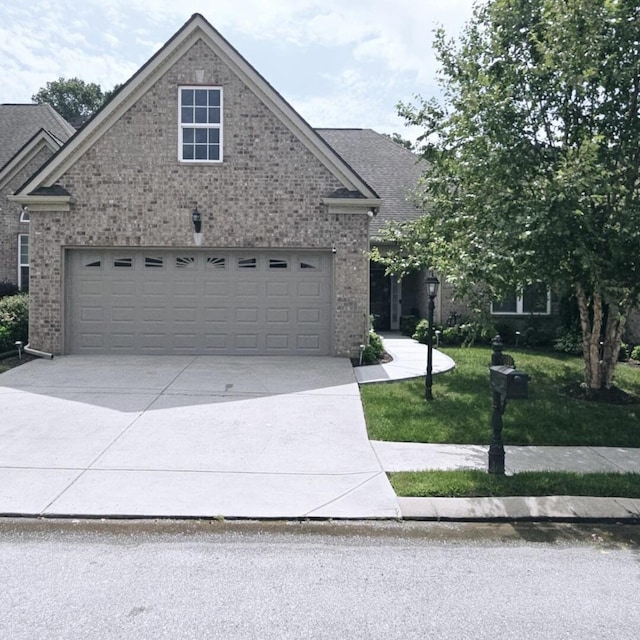 view of front of home featuring a front yard and a garage