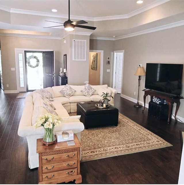 living room with ceiling fan, ornamental molding, and dark wood-type flooring