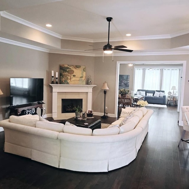 living room with ceiling fan, dark hardwood / wood-style floors, a fireplace, and crown molding