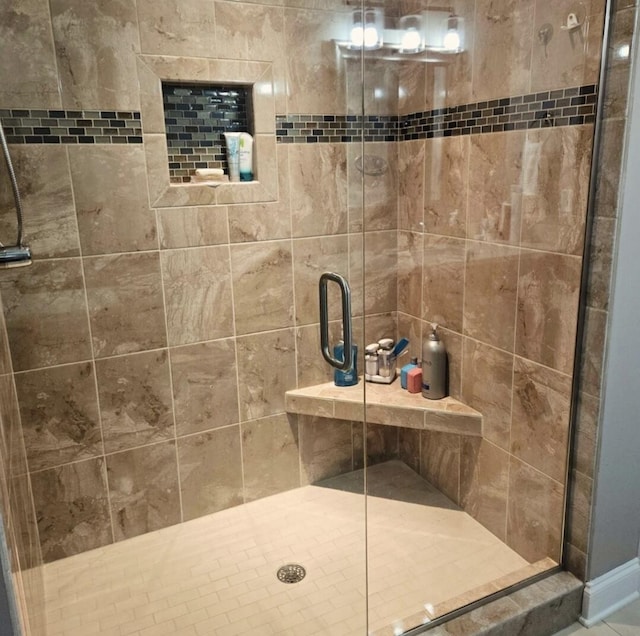 bathroom featuring a shower with door