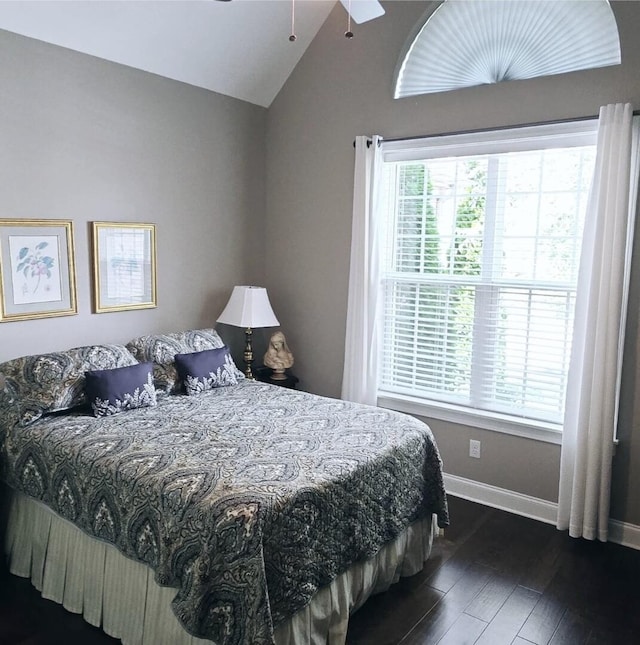 bedroom featuring vaulted ceiling, dark hardwood / wood-style floors, and ceiling fan