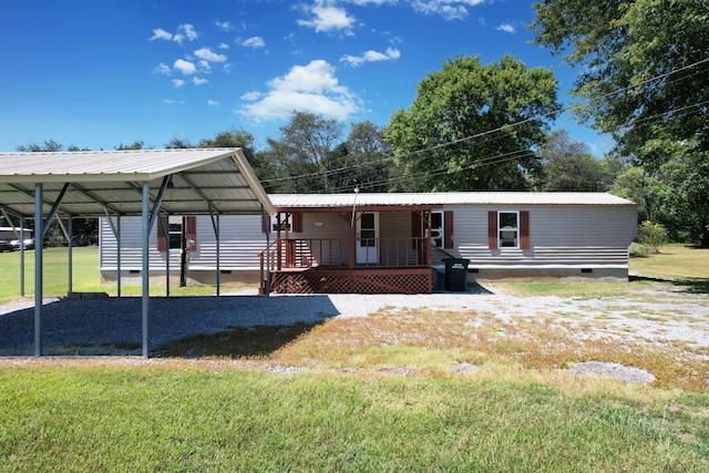 rear view of house featuring a lawn and a carport