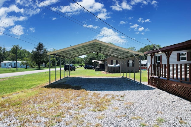 view of parking with a yard and a carport