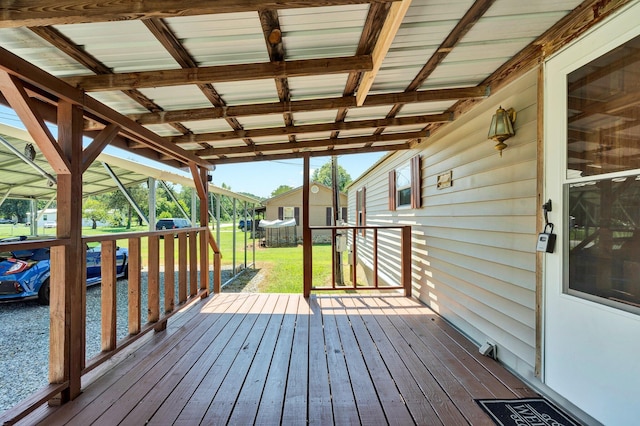 deck with a shed and a lawn