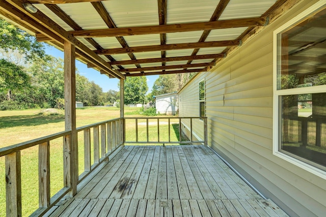 wooden terrace with a yard