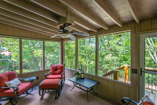 sunroom / solarium with wood ceiling, lofted ceiling with beams, and ceiling fan