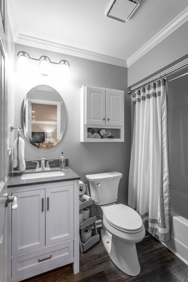 full bathroom with shower / bath combo with shower curtain, vanity, crown molding, hardwood / wood-style flooring, and toilet