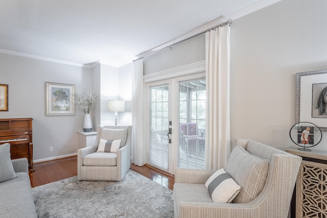 living room with ornamental molding and light hardwood / wood-style flooring