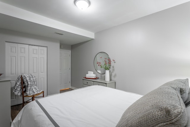 bedroom with a closet and dark hardwood / wood-style flooring