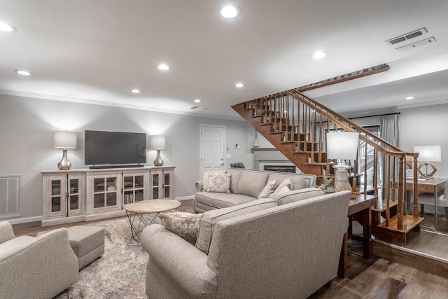 living room with ornamental molding and dark hardwood / wood-style flooring