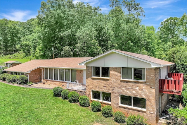 rear view of property featuring a yard