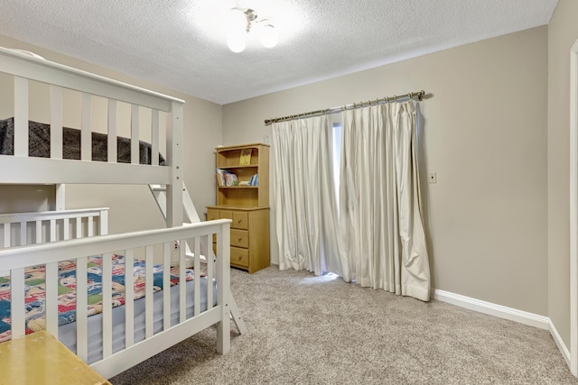 carpeted bedroom featuring a textured ceiling